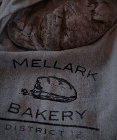 there is a bag with some food on it and the words mellark bakery district 12 printed on it