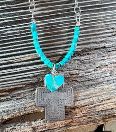 Sterling Silver Southwestern Necklace  features a cross pendant made of sterling silver, adorned with a Kingman turquoise heart bead. The pendant is suspended on an 18-inch long sterling silver chain. This necklace offers a unique and eye-catching blend of craftsmanship and natural beauty. Heart Cross Necklace, Southwestern Necklace, Turquoise Heart, Kingman Turquoise, A Cross, Happy Colors, Heart Beads, Sterling Silver Chain, Cross Pendant