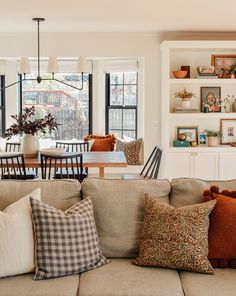 a living room filled with furniture and lots of windows