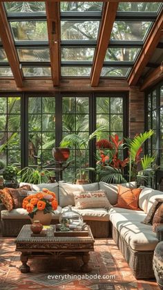 a living room filled with furniture and lots of windows