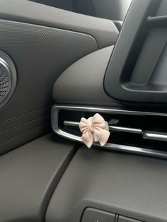 a car dashboard with a bow on the center console