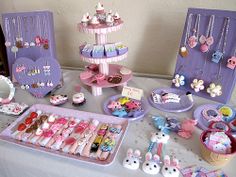 a table topped with lots of toys and accessories on top of a white table cloth