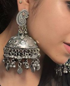 Add charm and charisma to your beautiful personality with these exquisitely designed and handcrafted high quality earrings in antique silver look.Pair them up with any formal or semi formal attire and gather compliments wherever you go. Suitable for both casual and dressy occasions.Each earring weighs only 30 GM's (lightweight)Length 3.8 inches Light weight*****************************************Note: All in stock items will be shipped from New Delhi, India within 2-3 business days after receip Silver Tilla Jhumkas For Festival, Ornate Heavy Jhumkas, Ornate Chandbali Metal Danglers, Ornate Metal Chandbali Danglers, Heavy Ornate Jhumkas, Bohemian Metal Jhumkas, Ornate Chandbali Jhumkas With Oxidized Finish, Handmade Silver Bohemian Jhumkas, Ornate Chandbali Oxidized Jhumkas