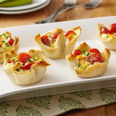 small appetizers are arranged on a white plate