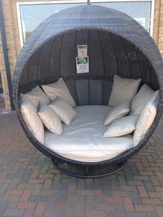 a round bed with pillows on top of it