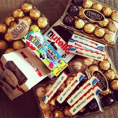 a box filled with lots of different types of chocolates and candies next to each other