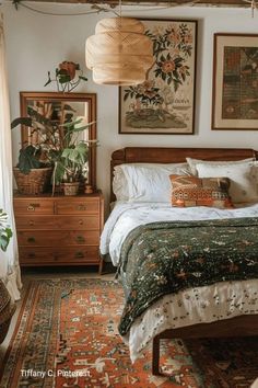 a bed room with a neatly made bed and lots of pictures on the wall above it