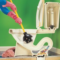 a person in pink gloves cleaning a toilet with a plunger and cleaner's mitt