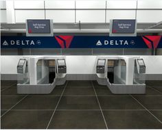 an airport terminal with two automated turnsets and signs on the wall that say delta