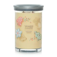 Buttery rich, vanilla scented, holiday sugar cookies. Experience the Yankee Candle® brand, totally reimagined. A fresh take on our Tumbler shape features a brushed tin lid that fits neatly under the base to serve as a candle coaster. Two cotton wicks and a premium soy-wax blend provide beautiful ambiance. Hand-illustrated labels and vibrant wax colors are perfectly matched with Collection-exclusive and tried-and-true fragrances to create an inspired addition to your home Christmas Cookie 20 oz. Signature Large Tumbler Candle, 20 oz Cookie Candle, Yankee Candle Christmas, Holiday Sugar Cookies, Candle Obsession, Candle Cookies, Candle Design, Yankee Candles, Holiday Candle, Aesthetic Candles