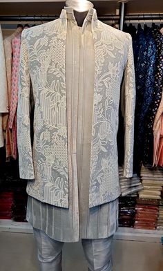 Art Dupion Raw Silk Swede Gray Velvet suit   Imported Fabric  Style : Ethnic Men Wear Top Details : Color -Gray Imported Valve Sherwani   Bottom -Gray Pant pajama  Top Fabric - Hand Embroidery  ( Achkan Style ) Indo-westerns style  Design : Achkan Style  Work Details : full  Embroidery over coat Size are : Very Small - 34inch Small 36inch Medium - 38inch Large - 40inch XLa-rge - 42inch 2XLarge - 44inch 3XLarge - 46inch 4XLarge - 48inch 5XLarge - 50inch 6XLarge - 52inch A little bit variation in colour may possible due to light effect, camera resolution and Monitor resolution. However you can ask for clear videos and pictures of the actual fabric which can be shared on whatsapp.  Note : We also ship matching mojari Indian Shoes) with this product on an extra cost. Please send us a message f Designer Raw Silk Bandhgala With Chikankari Embroidery, Transitional Bandhgala In Raw Silk With Chikankari Embroidery, Festive Bandhgala With Chikankari Embroidery For Designer Wear, Jamawar Nehru Jacket With Chikankari Embroidery For Transitional Season, Transitional Jamawar Nehru Jacket With Chikankari Embroidery, Designer Front Open Kurta With Cutdana, Fitted Nehru Jacket With Naqshi Straight Kurta, Fitted Nehru Jacket With Naqshi In Straight Kurta Style, Front Open Chikankari Embroidery Kurta