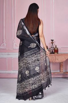 Flaunt your elegant style every day in this elegant black floral print linen saree with silver zari border. It comes with a matching blouse piece. Disclaimer: The shown stitched blouse on the model is for display purpose only. The saree comes with a matching blouse piece and finished with fall and piko. Black Block Print Dupatta, Black Block Print Saree With Traditional Drape, Black Saree With Block Print And Traditional Drape, Silver Chanderi Saree, Indian Clothing Store, Tussar Silk Sarees, Latest Designer Sarees, Linen Saree, Fashion Journals