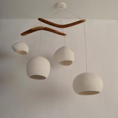 a group of white balls hanging from a ceiling