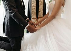 a bride and groom hold hands during their wedding ceremony