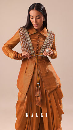 Experience the splendor of our copper brown kurta and palazzo set.
The jacket is detailed with cutdana and sequins.
This set is made from crepe tussar fabric.
This outfit is ideal for mehendi and sangeet events.
The kurta is coupled with a jacket and dhoti. Dhoti Pattern, Marriage Suits, Dotti Dresses, Kurta And Palazzo, Designer Anarkali Dresses, Fashion Show Dresses, Cocktail Outfit, Indian Dresses Traditional, Traditional Indian Outfits