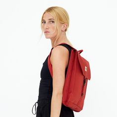 The smaller version of our Handy backpack. Its slim profile comfortably fits a 13, 6” laptop and the water-resistant fabric makes it the perfect choice for daily commuting. The Handy comes with a single strap closure with a metal hook, and features an inside zippered pocket and a quick access back pocket.  Slim main compartment with flap and metal hook closure.  13, 6” Laptop pocket.  Adjustable padded straps.  Quick-access zipper back pocket. Inside water bottle pocket.  Water-resistant.  Rpet & Vegan. Shell material: Recycled polyester from PET bottles with durable, Water-resistant and TPE coating.  Lining material: Recycled polyester from PET bottles.  Wash cold, line dry. Rectangular Red Backpack For Daily Use, Red Rectangular Travel Backpack, Rectangular Red Travel Backpack, Red Backpack With Zipper Closure, Red Backpack With Removable Pouch For On-the-go, Animal Print Party, Corporate Chic, Stocking Fillers For Her, Holiday Party Outfit