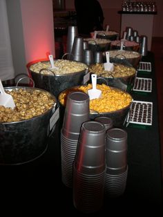 several buckets filled with food sitting on top of a table