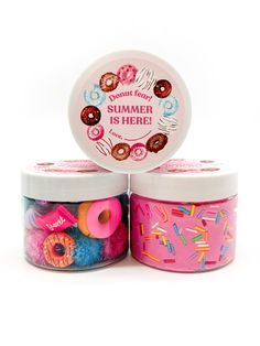 two jars filled with donuts and sprinkles on top of each other