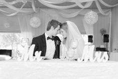 the bride and groom are kissing at their wedding reception