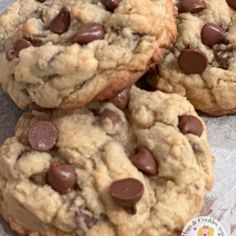 three chocolate chip cookies sitting on top of each other