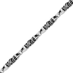 an intricate silver bracelet with skulls and hearts on it's side, in the shape of a chain