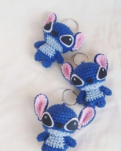 three crocheted keychains with small blue and pink mice on them