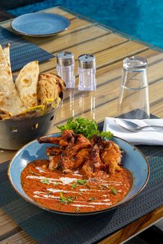 a plate of food on a table next to a pool