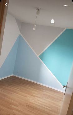 an empty room with blue and white walls