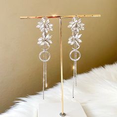 Our Amaryllis Rhinestone Earrings are statement-making earrings that sparkle and shine with a floral motif and cascading chains of falling rhinestones. Perfect for when you want to add that final touch that will catch the spotlight. These glamorous earrings are perfect for special occasions and dancing through the night! About 6 inches long at its longest This is a special occasion item = FINAL SALE Glamorous Earrings, Making Earrings, Sparkle And Shine, Final Touch, Rhinestone Earrings, Floral Motif, 6 Inches, Final Sale, Silver Earrings