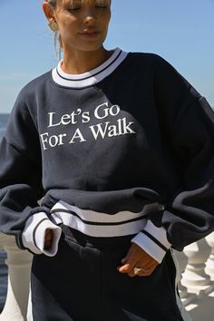 Let's go for a walk. For a minute or a mile, this oversized fleece is here to fuel inspiration on your daily journey. Featuring simple yet quality thick puff printing in a classic white coloring. Let's Go For A Walk design on chest in simple text Dark navy coloring Thick puff printing Wear with the Tearaway Fleece Pants in Navy Ribbed trim along wrists, neck, and waistband Soft, fuzzy interior Measurements for size S — bust: 52 inches, length: 24 inches This sweatshirt is made from 100% recycled Sweat Oversize, Minimal Shirt Design, Oversize Tshirt Outfits, Go For A Walk, Womens Crewneck, Tennis Clothes, Tshirt Outfits, Tee Outfit, Fleece Pants