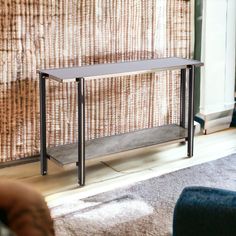 a metal shelf sitting on top of a wooden floor next to a wall covered in woven fabric