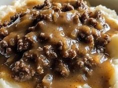 mashed potatoes topped with meat and gravy