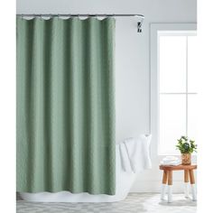 a green shower curtain in a bathroom