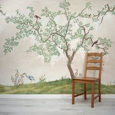 a wooden chair sitting in front of a tree with birds on it's branches