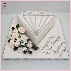 a birthday cake with flowers and a diamond on top that says congratulations to someone special