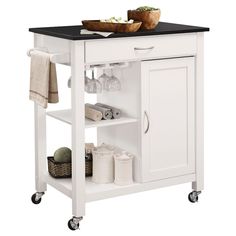 a white kitchen island cart with black top and drawers on casteors, holding food items