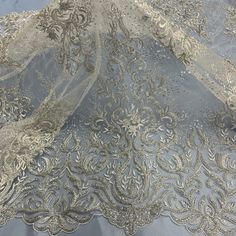 Elevate your special occasion wardrobe with one-of-a-kind elegance! Our exquisite Beaded & Corded Bridal Lace Fabric Embroidered on 100% Polyester Net Mesh is a stunning option for all your formalwear needs. This lace is handcrafted to perfection and is available in four distinct colors. With the perfect blend of beaded and corded detailing, this lace fabric is perfect for creating truly spectacular wedding dresses, evening gowns, dance costumes and quinceanera dresses. Whether you choose to ado Elegant Organza Lace With Floral Embroidery, Elegant Lace Fabric With Resham Embroidery, Elegant Fitted Embroidered Fabric For Ceremony, Elegant Floral Embroidered Organza Lace, Elegant Floral Embroidery Organza Lace, Elegant Embroidered Lace For Party, Elegant Festive Lace With Floral Embroidery, Elegant Floral Embroidered Lace For Festive Occasions, Elegant Embroidered Organza Lace