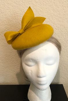 OVERVIEW -------------- This design was inspired by those of Duchess of Cambridge - Kate Middleton's fascinators. This hat would look much better if you wear it on the right side of the head. DETAILED DESCRIPTION --------------------------------- This listing is for a chic handmade 100% Merino wool fascinator hat in Mustard Yellow color,  deepest purple, the most majestic shade especially for the winter season! It features a cute looped bow - full of elegance and character.  I could make this design in more than 100 colors, just message me or leave me a note during checkout.  Wool fascinators are not just for the royalty or the high society. Everyone looks at their best wearing them and they are appropriate on nearly all occasions. They are not flashy or swanky: instead, they are the embod Yellow Bow, Fascinator Hat, Metal Headbands, Pillbox Hat, Dark Brown Color, High Society, Fascinator Hats, Color Swatch, Bridal Pearls