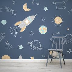 a space themed wallpaper with rockets and stars in the sky, against a blue background