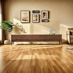 a living room with wood floors and pictures on the wall