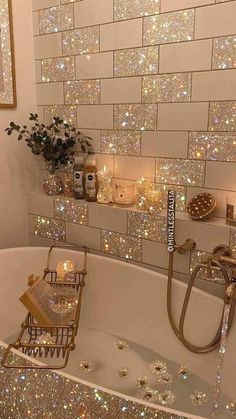 a bathtub filled with lots of sparkle next to a painting on the wall and candles