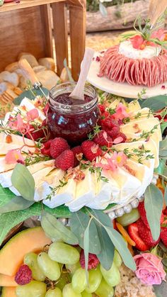 an assortment of fruits and cheeses on a table