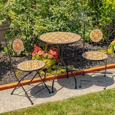 an outdoor table and chairs with flowers in the background