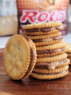 a stack of cookies with chocolate drizzled on them next to a bag of rocko