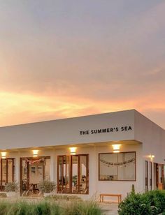 the summer's sea restaurant is lit up at dusk