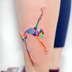 a person with a colorful tattoo on their leg