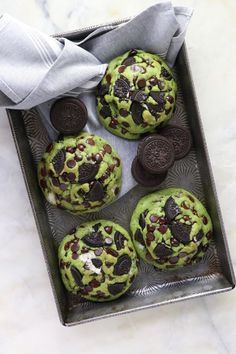 cookies and oreo cookies on a cookie sheet with green frosting in the middle