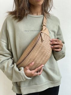 "Check out our other products from our shop below:  https://www.etsy.com/shop/MANDRNdesign Each Woven Atlas Leather Fanny Pack is handmade by highly skilled artisans specializing in the creation of hand-woven and braided leather accessories. Using double the amount of leather of our regular Remy packs, the woven nature of these bags means no two are the same and each pack is as unique as the MANDRN muse who wears it.    PRODUCT FEATURES: - 100% genuine leather in a nude/beige tone - Premium cowhide leather  - Handmade and hand-woven with love by our artisan friends in Bali - Inner pocket with a cotton-drill lining - Hidden top-flap pocket for small items like SIM cards, earrings, rings or emergency Advil - Two inner elastics to hold your lipsticks, essential oil rollers and similar essenti Mandrn Bag, Over The Shoulder Bags, Waist Pouch, Bag Belt, Leather Fanny Pack, Sand Beige, Bum Bag, Leather Pattern, Fashion Baby