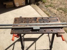 an old metal workbench sitting on the sidewalk