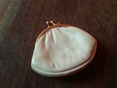 This  small super soft leather French Coin Purse is a wonderful antique accessory to hold your coins or other small trinkets in your purse. It would have been used in the early 1900s to hold coins for alms, tipping or purchases. The exterior of the coin purse is made of quality leather in ecru white. There is a gold metal kiss lock clasp that closes securely. The interior is lined in white silk taffeta lining.   It measures: 7 cm (2 3/4 inches) wide at its widest and 5.5 cm (2 1/4 inches) from b Classic Beige Coin Purse As Gift, Classic Gold Coin Purse For Everyday Use, Classic Gold Coin Purse As Gift, Gold Coin Purse With Coin Pocket As A Gift, Gold Coin Purse For Daily Use, Gold Coin Purse As Gift, Classic Gold Coin Purse For Daily Use, Gold Coin Purse With Coin Pocket For Formal Occasions, Compact Gold Coin Purse With Coin Pocket